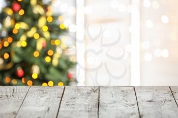 Empty wooden table against blurred Christmas lights�