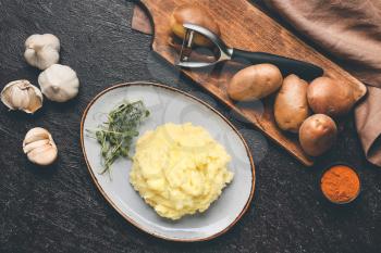 Composition with tasty mashed potato and garlic on table�