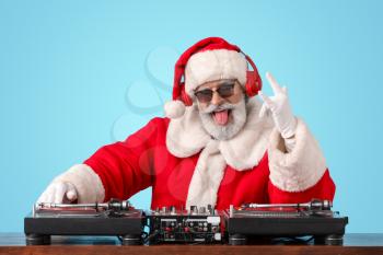 Cool Santa DJ playing music on color background�