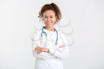Portrait of female doctor on light background�