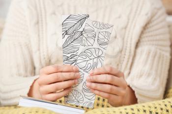 Woman with cute bookmarks at home�