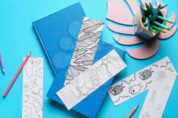 Cute bookmarks with books on color background�