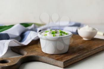 Bowl of tasty sour cream on table�