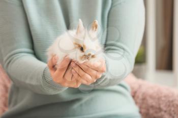 Woman with cute rabbit at home, closeup�