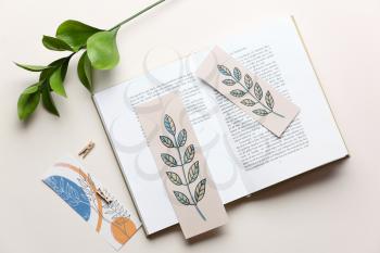 Book with bookmarks and branch on light background�