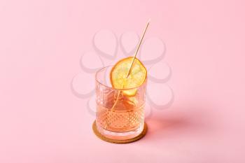 Glass of tasty cocktail on color background�