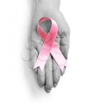 Female hand with pink ribbon on white background. Breast cancer awareness concept�