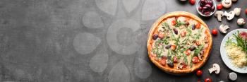 Delicious pizza and ingredients on table with space for text�