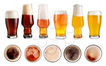 Glasses of different beer on white background�