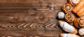 Tasty pastries on wooden background with space for text�