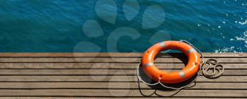 Lifebuoy ring on sea pier with space for text�