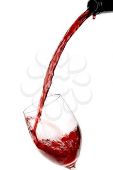 Red wine being poured into a wine glass.Isolated on white