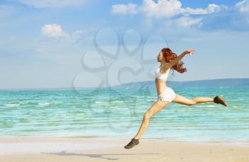 Young girl making exercise on the beach