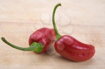 red hot chili peppers over wooden background 