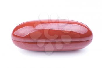 
single brown  oval capsule on white background 