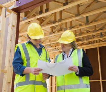 civil engineer and worker discussing issues at the construction site