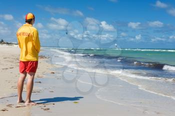 young man  life saver  watching the situation on the sea