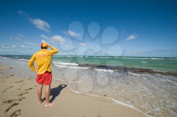 young man  life saver  watching the situation on the sea