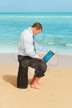 First day of vacation.Businessman  on the beach