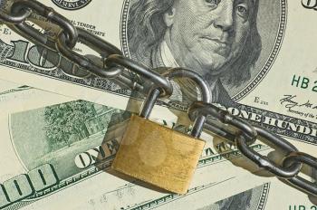 Financial security concept image
one hundred dollars locked  with padlock