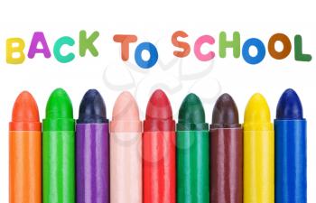 back to school background with wax multicolored crayons
