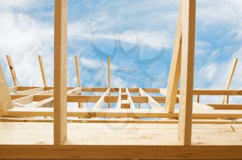 New residential construction home framing against a blue sky.Shallow focus.