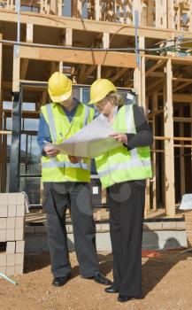 civil engineer and worker discussing issues at the construction site