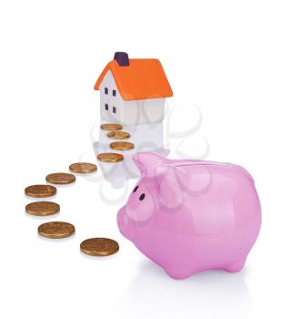 conceptual image with piggy  bank, coin and house