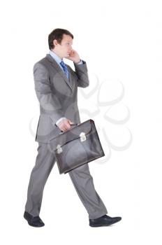 walking young businessman with briefcase isolated on white background