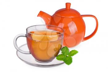 Glass cup of tea with mint leaves and orange teapot isolated on white background 