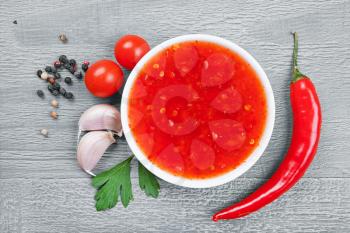 red hot chilli sauce over wooden vintage background