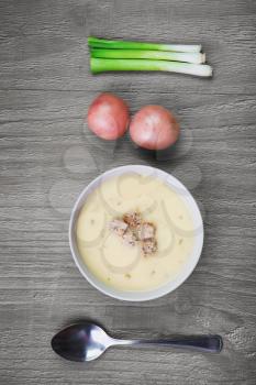 bowl of  fresh creamy potato soup on retro wooden table