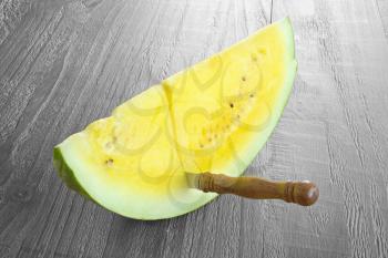 yellow watermelon on vintage wooden table 