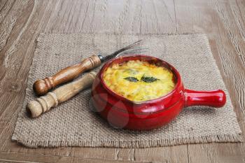julienne with mushrooms, cream and cheese on wooden background