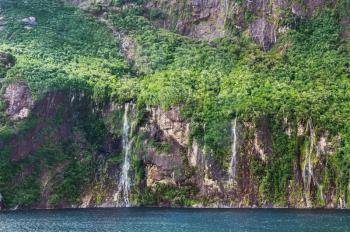 Rocks with Falls of Milford Sound fiord 
Fiordland national park, New Zealand