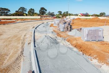 new sidewalk during construction and new plots for homes construction
