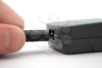 Royalty Free Photo of a Hand Plugging in a USB Cord