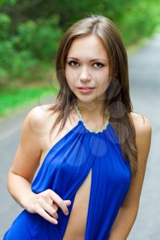 Royalty Free Photo of a Woman in a Short Blue Dress Standing on a Road