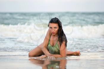 Nice young woman lying on the beach