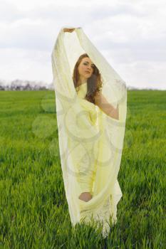 Attractive young woman wrapped in yellow cloth