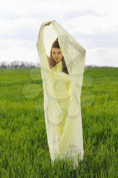 Charming young woman wrapped in yellow cloth