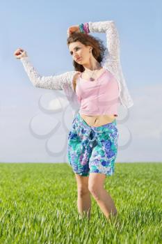 Cute young woman in a green field