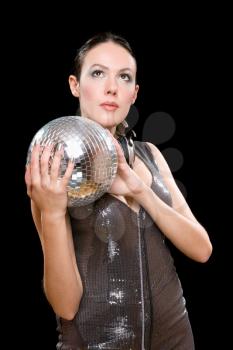 Portrait of attractive young brunette with a mirror ball in her hands. Isolated on black