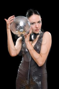 Portrait of attractive young woman with a mirror ball in her hands. Isolated on black