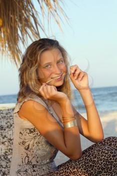 Portrait of happy teenage girl sitting on a lounge chair