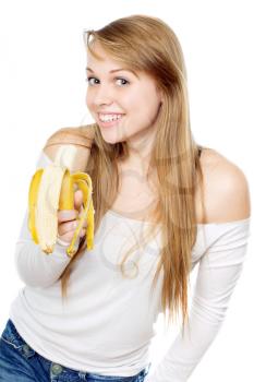 Playful young woman smiling and holding banana in her hand. Isolated on white