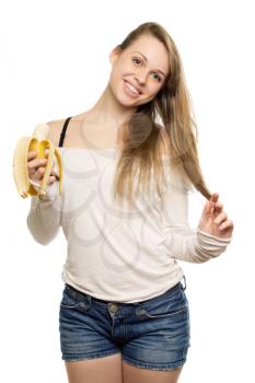 Pretty smiling woman holding banana and touching her blond hair. Isolated on white