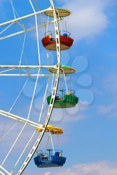 Three cabins Ferris wheel on a background of sky