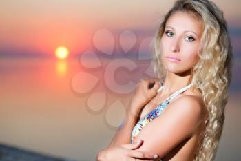 Portrait of attractive blond woman at the sunset