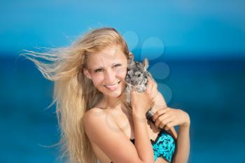 Portrait of smiling blonde posing with chinchilla